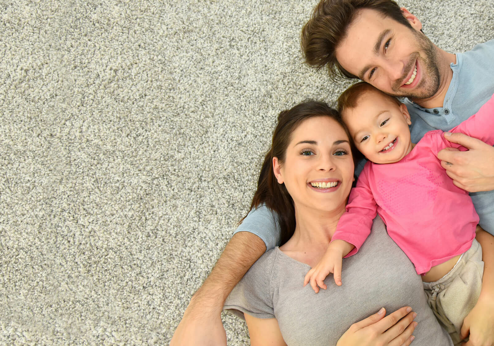 Family laying on carpet flooring | Floor Decor
